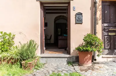 an entrance to a house with a door and plants at VII Coorte a Trastevere in Rome