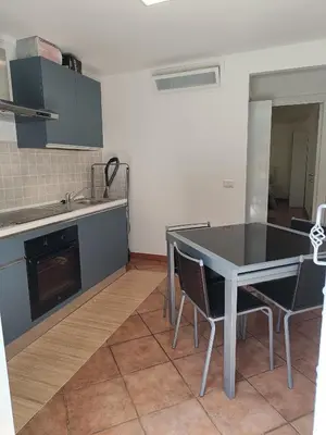 a kitchen with a table and chairs in a room at Suites in Rome in Rome