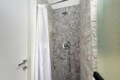 a bathroom with a shower with a shower curtain at Katia Charme in Rome