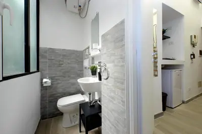 a bathroom with a white toilet and a sink at Katia Charme in Rome