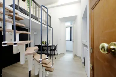 a room with a staircase and a table with chairs at Katia Charme in Rome