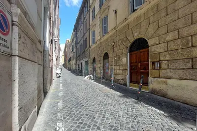 an empty street in an alley between buildings at Katia Charme in Rome