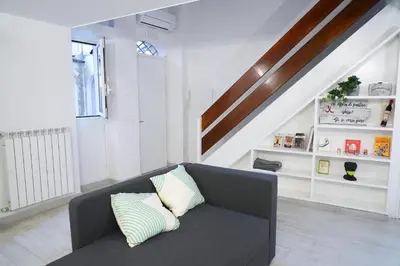 a living room with a couch and a staircase at Torretta Flat in Rome