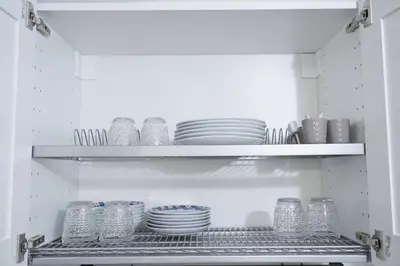 a refrigerator with plates and bowls on shelves at Torretta Flat in Rome