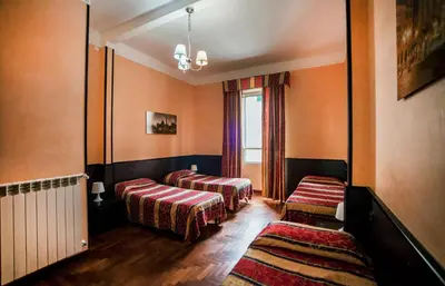 a room with two beds and a window at Funny Holiday in Rome