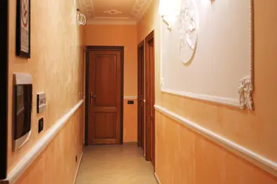 a hallway with a door and a television on a wall at Funny Holiday in Rome