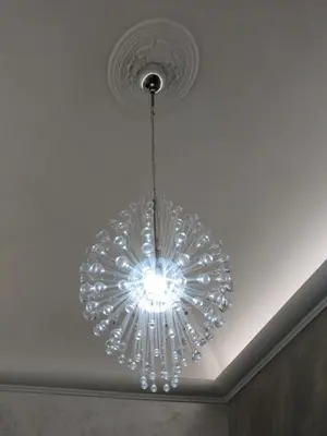 a glass chandelier hanging from a ceiling at Funny Holiday in Rome