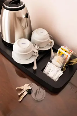 a tray with dishes and a tea pot and spoons at Stevenson Rooms in Rome