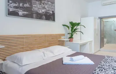 a bedroom with a bed with two towels on it at Le suite di Borgo in Rome