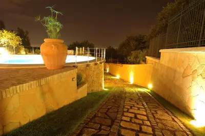 a garden with a bench and a fence at La Valle dei Casali Green Boutique in Rome
