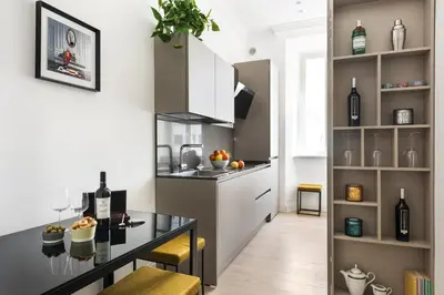 a kitchen with a counter with wine bottles on it at Idyllia - Elegant central flat in Rome