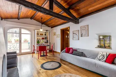 a living room with a couch and a table at Rome As You Feel - Librari Penthouse with Terrace in Rome