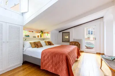 a bedroom with a large bed in a room at Rome As You Feel - Librari Penthouse with Terrace in Rome