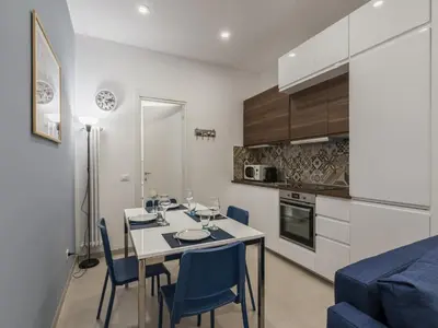 a kitchen and dining room with a table and chairs at The Best Rent - Two-bedroom apartment close to San Pietro in Rome