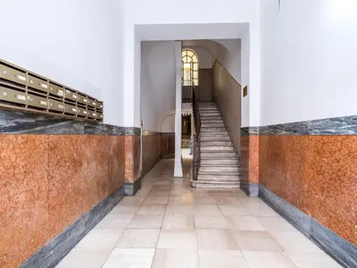 a hallway of a building with stairs and a stair case at The Best Rent - Two-bedroom apartment close to San Pietro in Rome