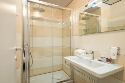 a bathroom with a sink and a shower at Arenula Suites in Rome