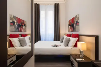 a hotel room with a bed and a mirror at Arenula Suites in Rome
