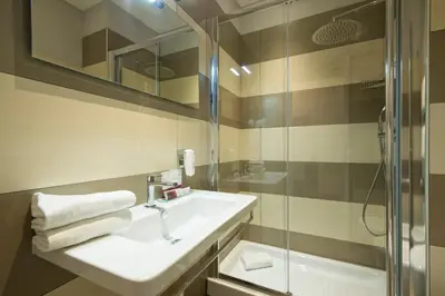 a bathroom with a sink and a shower at Arenula Suites in Rome