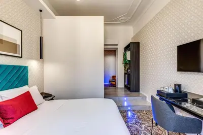 a hotel room with a bed and a tv at Arenula Suites in Rome