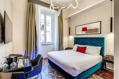a hotel room with a bed and a window at Arenula Suites in Rome