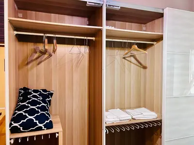 a walk in closet with wooden cabinets and a pillow at Un piacevole alloggio turistico in Rome