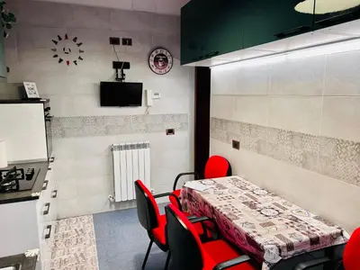 a dining room with a table and red chairs at Un piacevole alloggio turistico in Rome