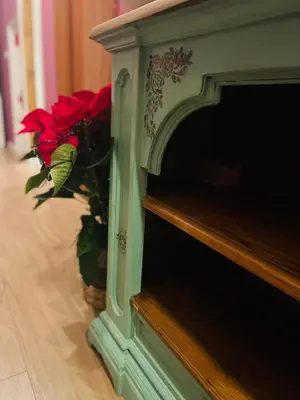 a red flower in a basket next to a fireplace at Termini Suite Inn Rome in Rome