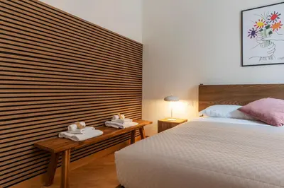 a bedroom with a bed and two towels on a table at Magnolia terrace at Vatican Museum in Rome