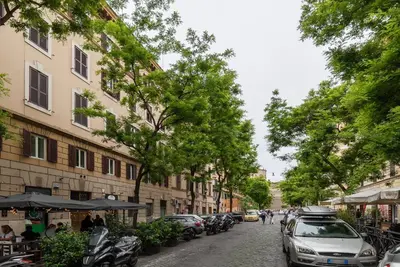 a street with cars parked on the side of the road at Magnolia terrace at Vatican Museum in Rome