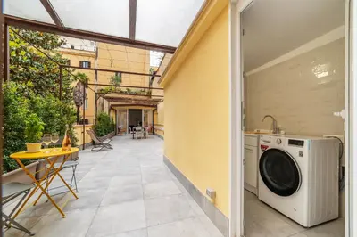 an outdoor patio with a washer and dryer in a house at Magnolia terrace at Vatican Museum in Rome