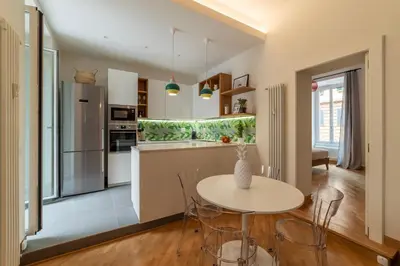 a kitchen with a table and chairs in a room at Magnolia terrace at Vatican Museum in Rome