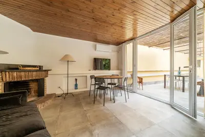 a living room with a fireplace and a table and chairs at Magnolia terrace at Vatican Museum in Rome