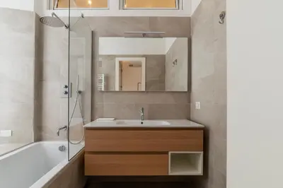 a bathroom with a sink and a tub and a mirror at Magnolia terrace at Vatican Museum in Rome