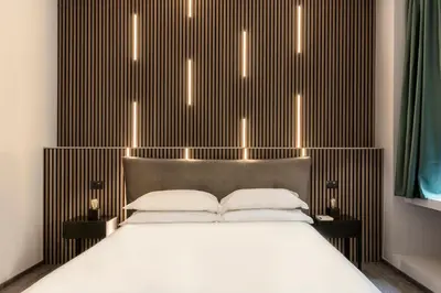 a bedroom with a bed with lights above it at Residenza Sacconi by Hili in Rome