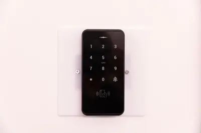 a black remote control on a white background at Residenza Sacconi by Hili in Rome