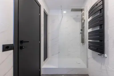 a bathroom with a shower with a glass door at Residenza Sacconi by Hili in Rome