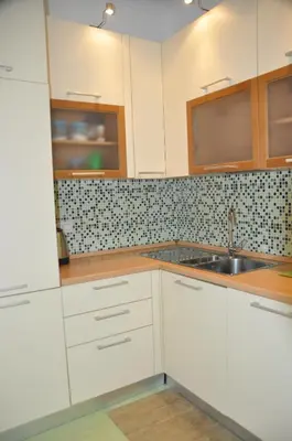 a kitchen with white cabinets and a sink at Mary's House in Rome