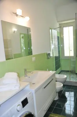 a bathroom with a sink and a toilet and a mirror at Mary's House in Rome