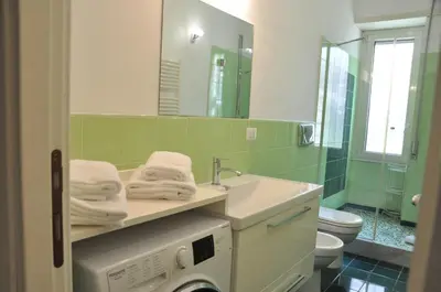 a bathroom with a sink and a washing machine at Mary's House in Rome