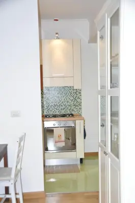 a kitchen with white cabinets and a stove at Mary's House in Rome