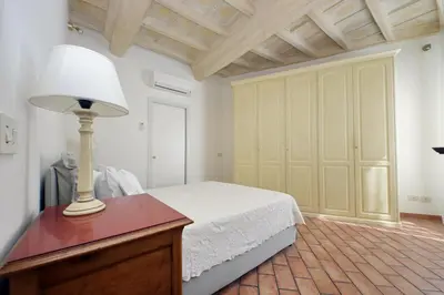 a bedroom with a bed and a lamp on a dresser at suity I cozy coronari apartment in Rome