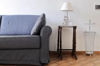 a living room with a blue couch and a lamp at suity I cozy coronari apartment in Rome