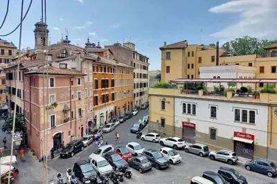 a city with cars parked on a street with buildings at suity I cozy coronari apartment in Rome