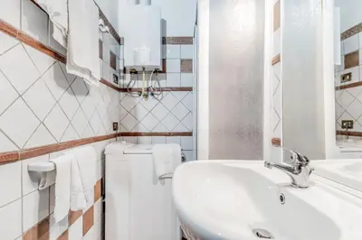 a white bathroom with a sink and a toilet at PANTHEON allo SCRIGNO in Rome