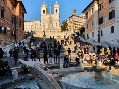 a group of people walking around a fountain in front of a building at PANTHEON allo SCRIGNO in Rome