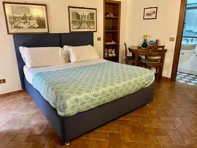 a large bed in a room with a table at PANTHEON allo SCRIGNO in Rome