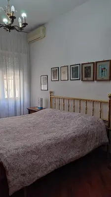 a bedroom with a bed with a pink bedspread at Montagnola House in Rome