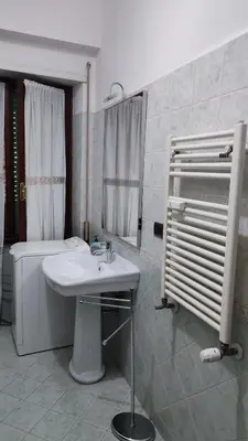 a bathroom with a sink and a tub and a toilet at Montagnola House in Rome