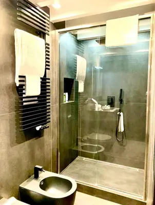 a bathroom with a shower and a toilet and a sink at Buonarroti Art Home - Luxury and Art in Rome in Rome
