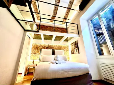 a bedroom with a large bed with a chandelier at Buonarroti Art Home - Luxury and Art in Rome in Rome